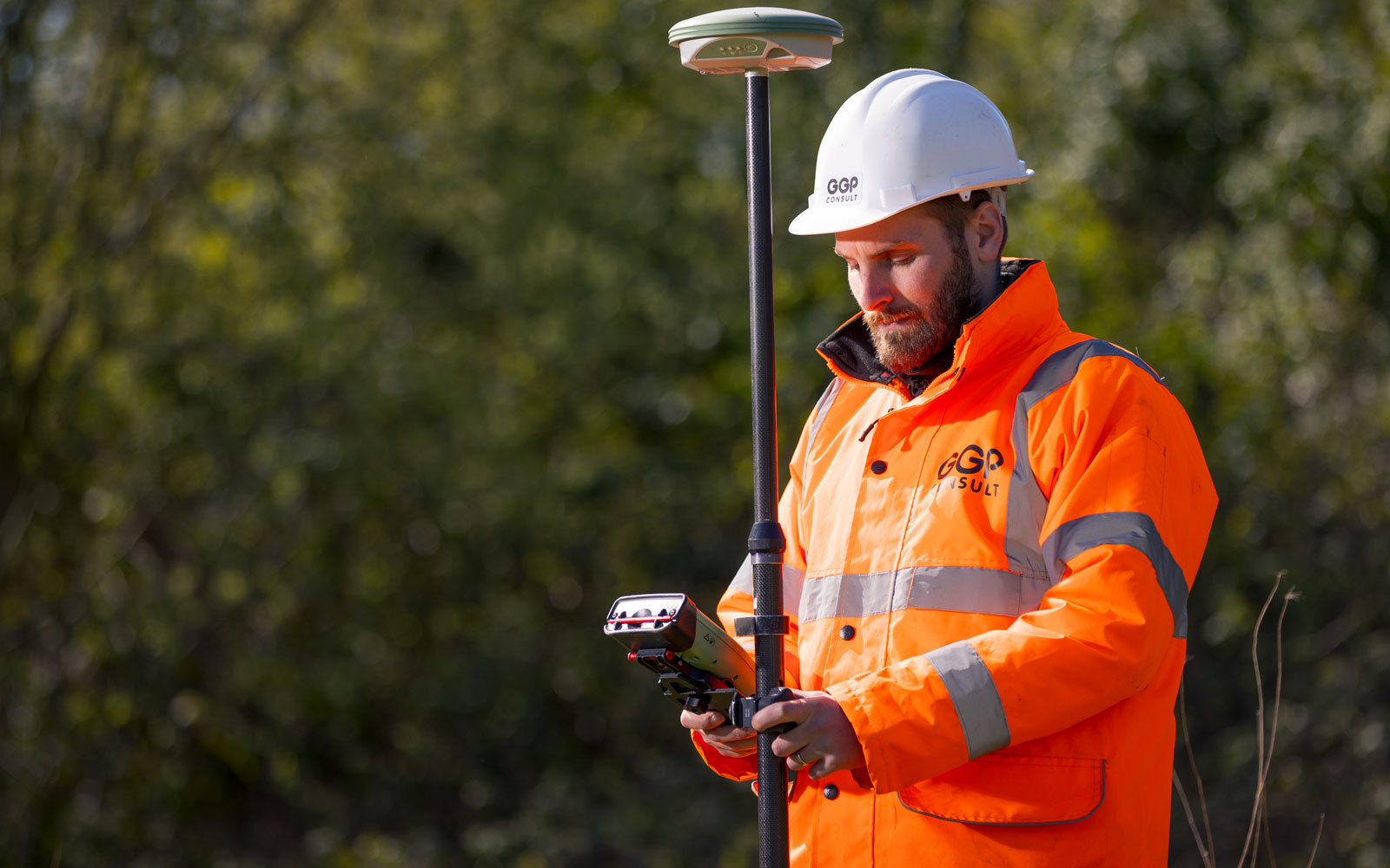 Two men in hard hats and hi-vis jackets.